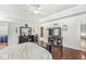 Large main bedroom with hardwood floors, tray ceiling, and adjacent bathroom at 7221 State Road 42, Martinsville, IN 46151