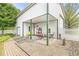 This outdoor patio beside the garage offers a charming space for relaxation with seating, decor, and white picket fence at 7221 State Road 42, Martinsville, IN 46151
