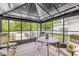 Enclosed gazebo featuring a dining table and chairs, providing a shaded outdoor dining experience by the pool at 7221 State Road 42, Martinsville, IN 46151