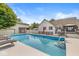 Backyard featuring an above-ground pool, a white picket fence, and a charming home in a lush, green setting at 7221 State Road 42, Martinsville, IN 46151