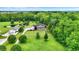 An aerial view of a home with a large yard, a pool and lush surrounding greenery and nearby pond at 7380 N 225 W, Lebanon, IN 46052