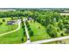 Aerial view of a serene property with a long driveway, lush greenery, pond, and inviting single-Gathering home at 7380 N 225 W, Lebanon, IN 46052
