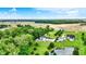An expansive property with multiple homes, a pool, and a pond surrounded by lush green landscape at 7380 N 225 W, Lebanon, IN 46052