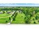 Aerial view showcasing a sprawling property with a well-manicured lawn, mature trees, and a charming home at 7380 N 225 W, Lebanon, IN 46052