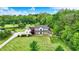 Aerial shot of a charming home with a large lawn, a lovely pond, and lush green trees at 7380 N 225 W, Lebanon, IN 46052