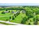 Expansive aerial shot showcasing multiple homes and large manicured lawns set amidst picturesque rural scenery at 7380 N 225 W, Lebanon, IN 46052