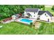 Aerial view of a large backyard featuring an inground pool, a pool house, an outdoor kitchen and a firepit at 7380 N 225 W, Lebanon, IN 46052