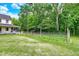 Expansive backyard with lush lawn, mature trees, and a fenced in chicken coop at 7380 N 225 W, Lebanon, IN 46052