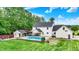 Aerial view of a large backyard featuring an inground pool, a pool house, an outdoor kitchen, and garden beds at 7380 N 225 W, Lebanon, IN 46052