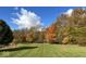 A sprawling backyard features lush grass, mature trees with colorful foliage at 7380 N 225 W, Lebanon, IN 46052