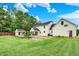 Back of house with in-ground pool, pool house, garden, and large manicured lawn at 7380 N 225 W, Lebanon, IN 46052