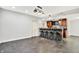 Finished basement featuring a bar area with seating for four, stylish lighting and tile backsplash at 7380 N 225 W, Lebanon, IN 46052