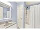 Bathroom features a shower with curtain, a sink, and a mirror at 7380 N 225 W, Lebanon, IN 46052
