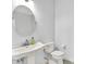 Charming half-bathroom with a pedestal sink, a round mirror, and a toilet at 7380 N 225 W, Lebanon, IN 46052