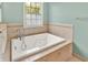 Large tiled bathtub next to a window allowing lots of natural light at 7380 N 225 W, Lebanon, IN 46052