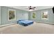 Spacious bedroom featuring carpet, a ceiling fan, and multiple windows providing ample natural light and outdoor views at 7380 N 225 W, Lebanon, IN 46052