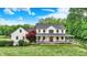 Charming two-story home with a welcoming front porch, beautiful lawn, and lush landscaping at 7380 N 225 W, Lebanon, IN 46052