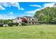 Lovely two-story home with a wide front yard, mature trees, and a charming covered porch at 7380 N 225 W, Lebanon, IN 46052