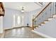 Welcoming foyer with tile flooring, elegant staircase, and ample natural light, perfect for guests at 7380 N 225 W, Lebanon, IN 46052