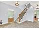 Spacious foyer with tile flooring, a beautiful staircase, and views into other living spaces at 7380 N 225 W, Lebanon, IN 46052
