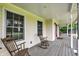 Relaxing front porch with rocking chairs and wood flooring, creating a cozy outdoor retreat at 7380 N 225 W, Lebanon, IN 46052