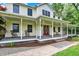 Inviting front porch with rocking chairs and brick accents, offering a relaxing outdoor space at 7380 N 225 W, Lebanon, IN 46052