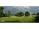 A rainbow over lush green lawn and trees in the background at 7380 N 225 W, Lebanon, IN 46052