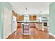 Bright kitchen with hardwood floors, kitchen island, and wooden cabinets at 7380 N 225 W, Lebanon, IN 46052