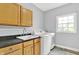 Functional laundry room with sink, countertop, and modern washer and dryer at 7380 N 225 W, Lebanon, IN 46052