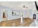 Open-concept living room with hardwood floors, a large mirror, and neutral paint at 7380 N 225 W, Lebanon, IN 46052