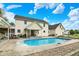Back of house with in-ground pool surrounded by stone pavers and landscaping at 7380 N 225 W, Lebanon, IN 46052
