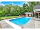 In-ground pool in backyard with pool house, swing set, and storage at 7380 N 225 W, Lebanon, IN 46052