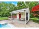 Pool house with an open-air patio, offering a comfortable space with chairs and a table at 7380 N 225 W, Lebanon, IN 46052