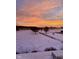 A scenic view of a snow-covered field with a colorful sunset backdrop at 7380 N 225 W, Lebanon, IN 46052