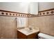 Well-lit bathroom showcasing tile and a classic vanity with a towel rack for convenience at 8027 S 250 E, Markleville, IN 46056