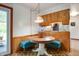 Cozy breakfast nook featuring wainscoting, a vintage light fixture, and an adjacent kitchen at 8027 S 250 E, Markleville, IN 46056