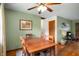 Dining room with hardwood floors, a wooden table and chairs, and a view to an adjacent living space at 8027 S 250 E, Markleville, IN 46056
