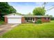 Charming brick ranch-style home featuring a well-manicured lawn, attached garage, and cozy front porch at 8027 S 250 E, Markleville, IN 46056