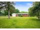 Quaint single story brick home with an attached garage, mature trees and lush green lawn at 8027 S 250 E, Markleville, IN 46056