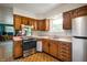 Traditional kitchen with wood cabinets, stainless steel appliances, and a bright window at 8027 S 250 E, Markleville, IN 46056