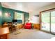 Inviting living room with mixed flooring, wainscoting, a red chair, and natural light at 8027 S 250 E, Markleville, IN 46056