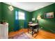 Dedicated office space with green walls, hardwood floors, and a desk area ready for productivity at 8027 S 250 E, Markleville, IN 46056