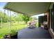 Covered patio overlooking a lush green yard and serene outdoor views, perfect for relaxation at 8027 S 250 E, Markleville, IN 46056