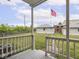 Private backyard featuring a deck, green grass, fenced yard, and detached garage at 914 English Ave, Indianapolis, IN 46203
