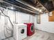 Functional basement with laundry area, including a washer and dryer and painted brick walls at 914 English Ave, Indianapolis, IN 46203