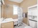 Cozy bathroom featuring a tub with shower, classic vanity, shelving, and neutral paint at 914 English Ave, Indianapolis, IN 46203