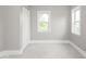 Bright bedroom featuring light grey walls, plush carpeting, white trim, and natural light at 914 English Ave, Indianapolis, IN 46203