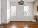 Bright and spacious dining room area featuring refinished hardwood floors and decorative lighting fixture at 914 English Ave, Indianapolis, IN 46203