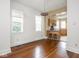 Open dining area with refinished hardwood floors, bright windows, and open kitchen view at 914 English Ave, Indianapolis, IN 46203
