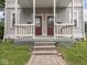 Inviting front porch showcasing dual entrances, classic railings, and a welcoming entry to each residence at 914 English Ave, Indianapolis, IN 46203